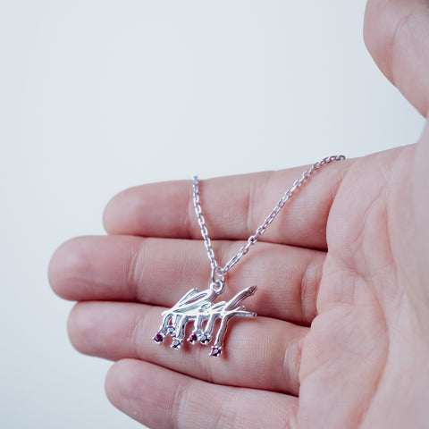 Silver-plated Red Necklace – worn on hand | Above Average